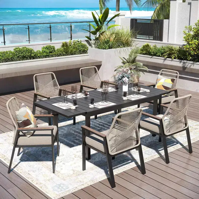 Captiva Designs Set da 7 Pezzi da Pranzo per Patio con Tavolo in Acciaio con Piano a Liste e Sedie in Rattan Beige con Cuscini